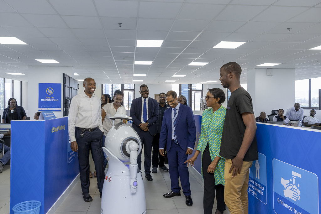 Delegates explore an AI robot at the summit exhibition